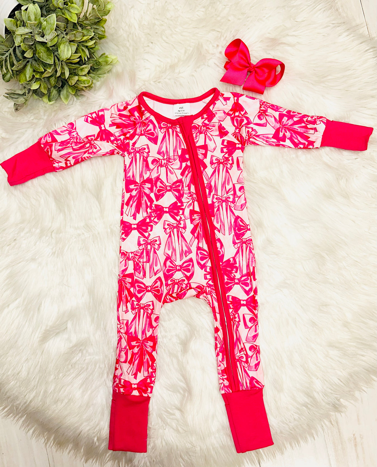 Girl’s dark pink bow sleeper