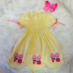 Girl’s yellow and pink crayon with pink ribbons on sleeve dress
