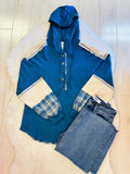 Women’s blue hooded top with plaid sleeves