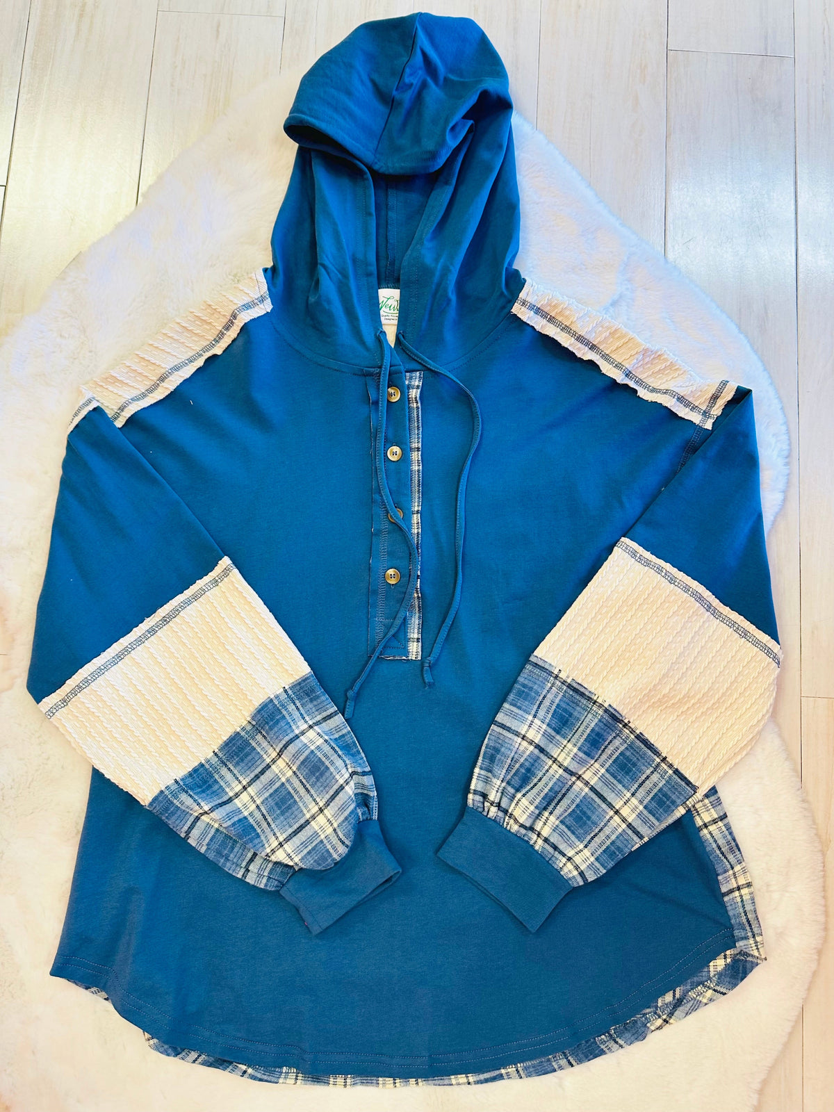 Women’s blue hooded top with plaid sleeves