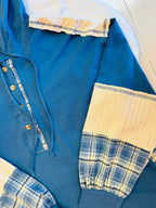 Women’s blue hooded top with plaid sleeves