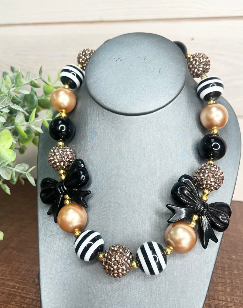 Chunky black and gold bow necklace