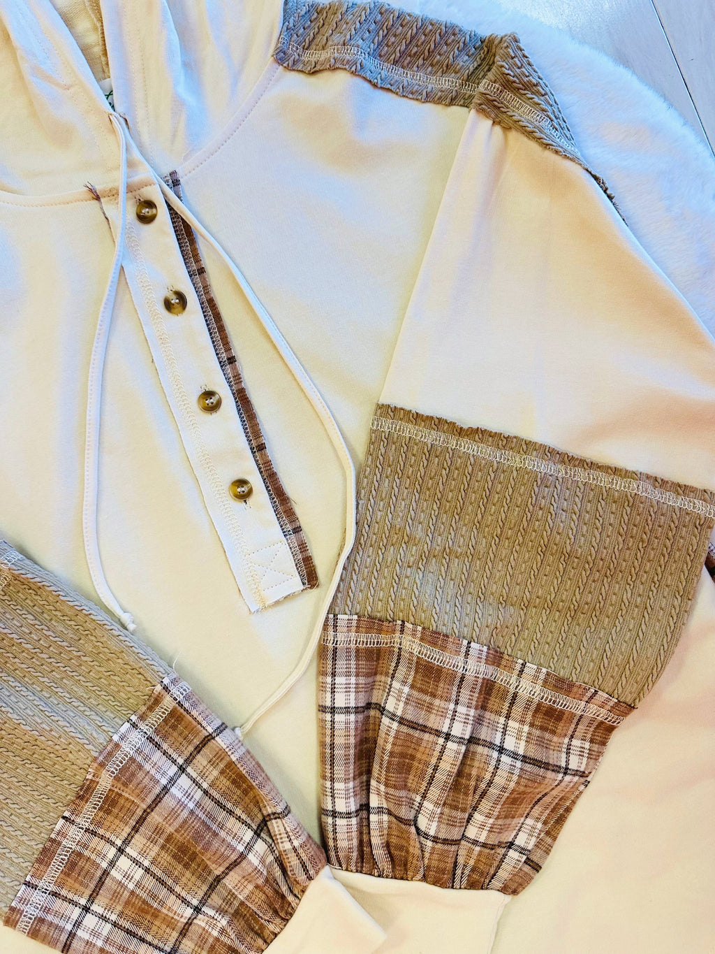 Women’s cream hooded top with plaid sleeves