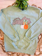 Women’s Sage Green Crewneck Features a cute Leopard - Print outline of Kentucky paired with stacked Autumn Pumpkins