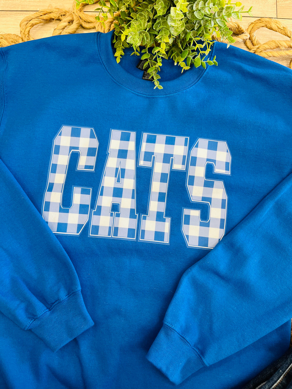 Women’s Royal Blue Crewneck Features blue-and-white gingham “CATS”
