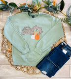 Women’s Sage Green Crewneck Features a cute Leopard - Print outline of Kentucky paired with stacked Autumn Pumpkins