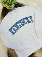 Women’s Kentucky Embroidered Checkered Pattern Mockneck Pullover Top