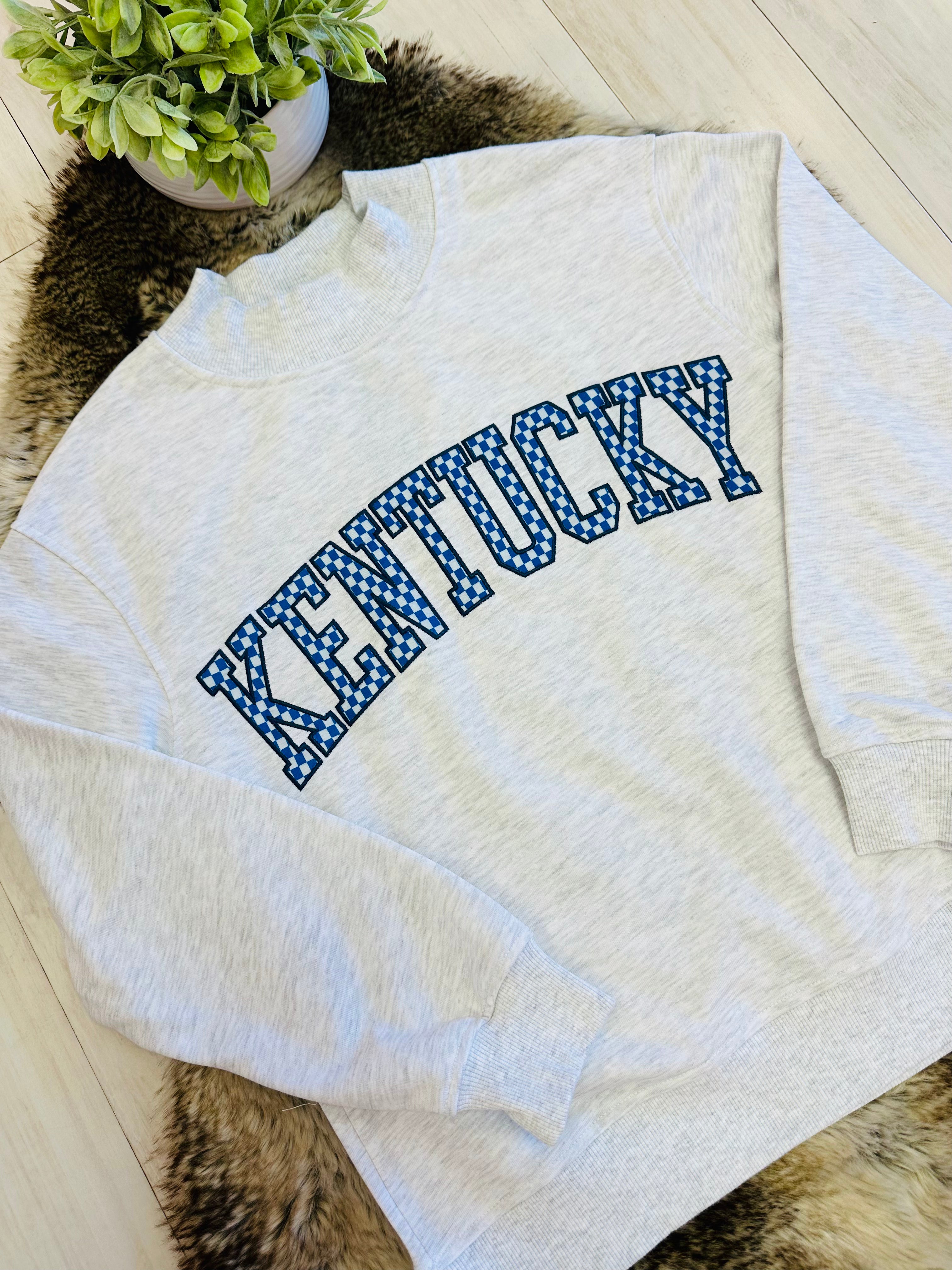 Women’s Kentucky Embroidered Checkered Pattern Mockneck Pullover Top