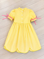 Girl’s yellow and pink crayon with pink ribbons on sleeve dress