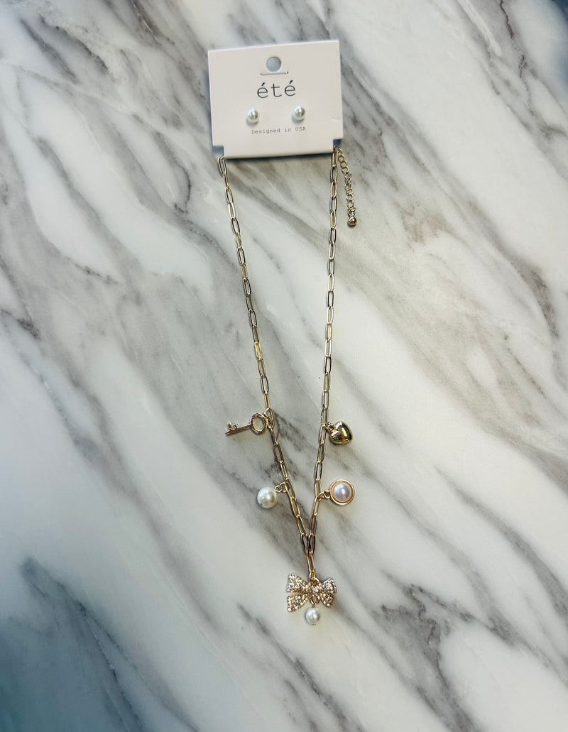 Women’s Pearl Earrings and Charm Necklace