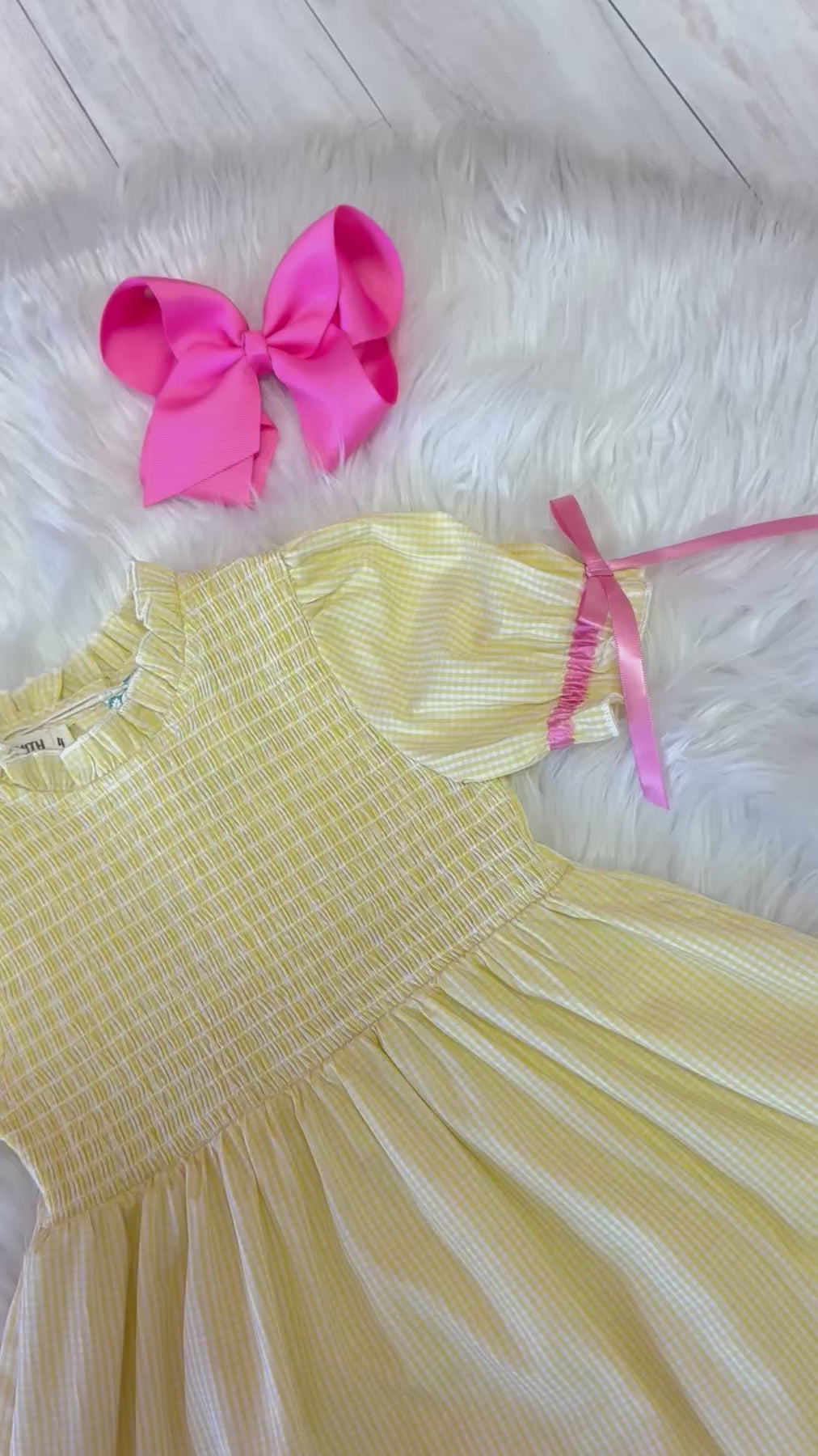 Girl’s yellow and pink crayon with pink ribbons on sleeve dress